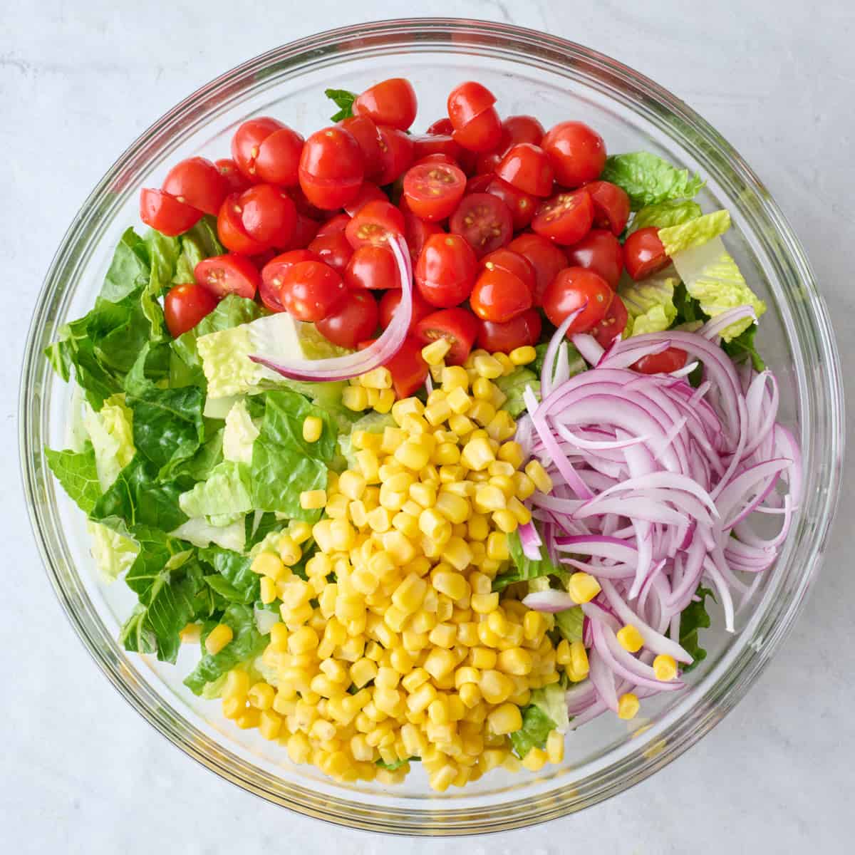 Lettuce, tomatoes, corn, and onion added.