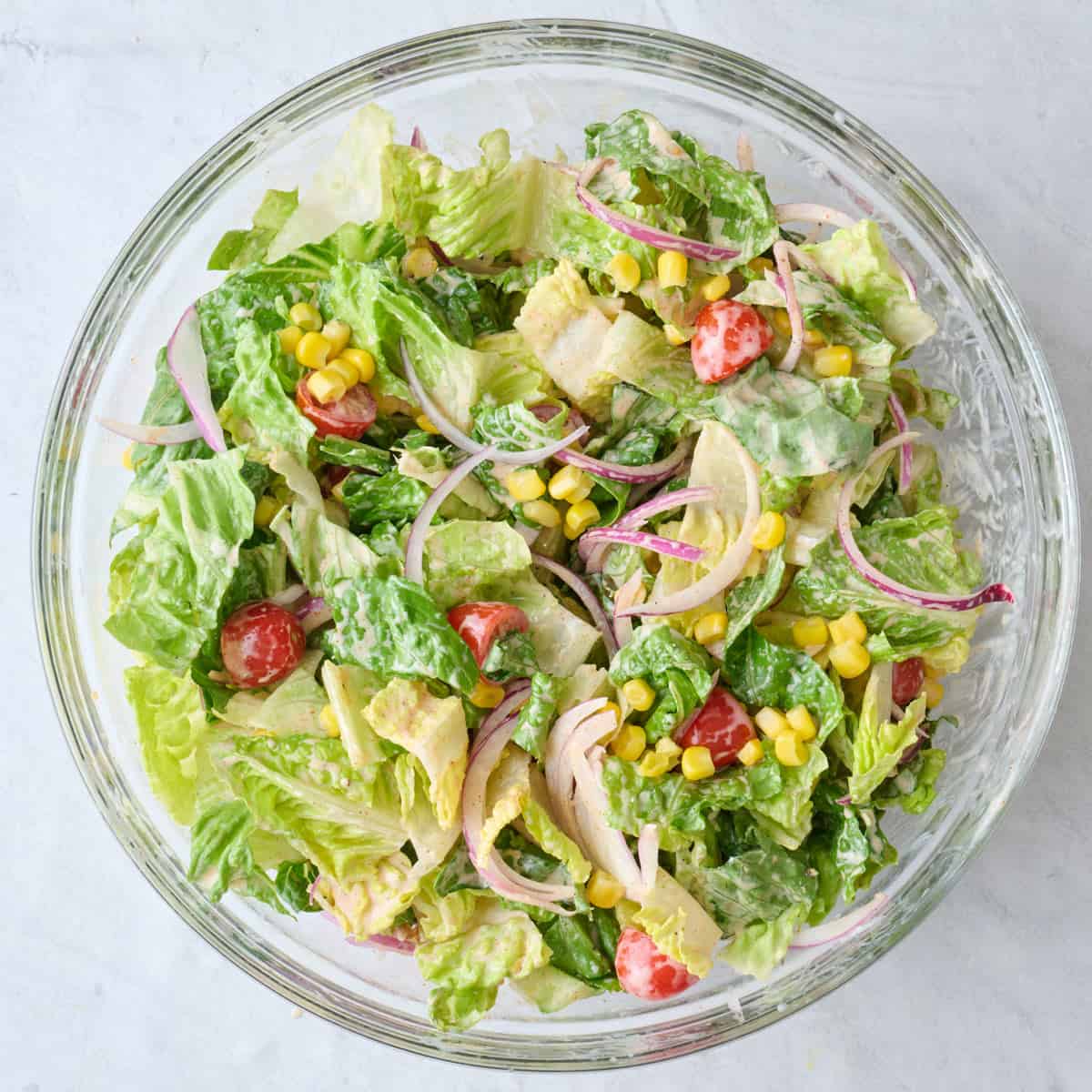 After tossing salad with dressing and veggies.