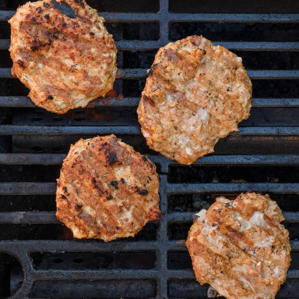 Turkey burgers on grill after grilled.