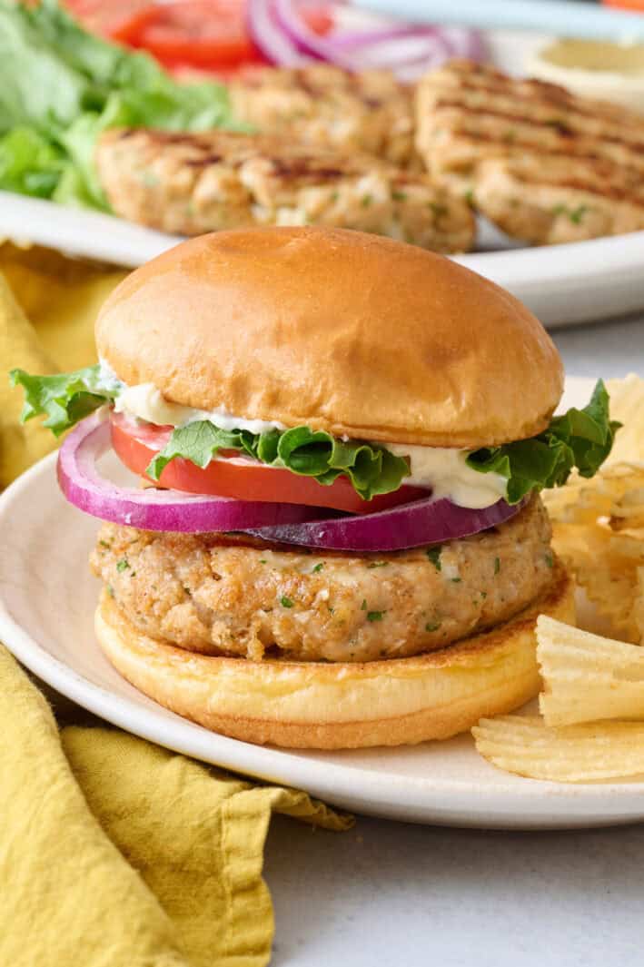 Homemade ground chicken burger recipe on bun with toppings.
