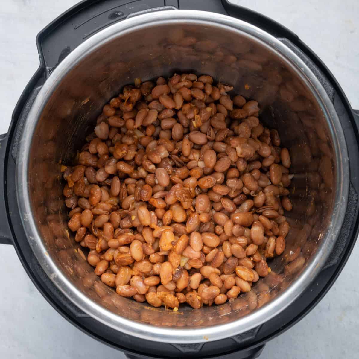 Beans added back to pressure cooker and tossed in sauce ingredients.