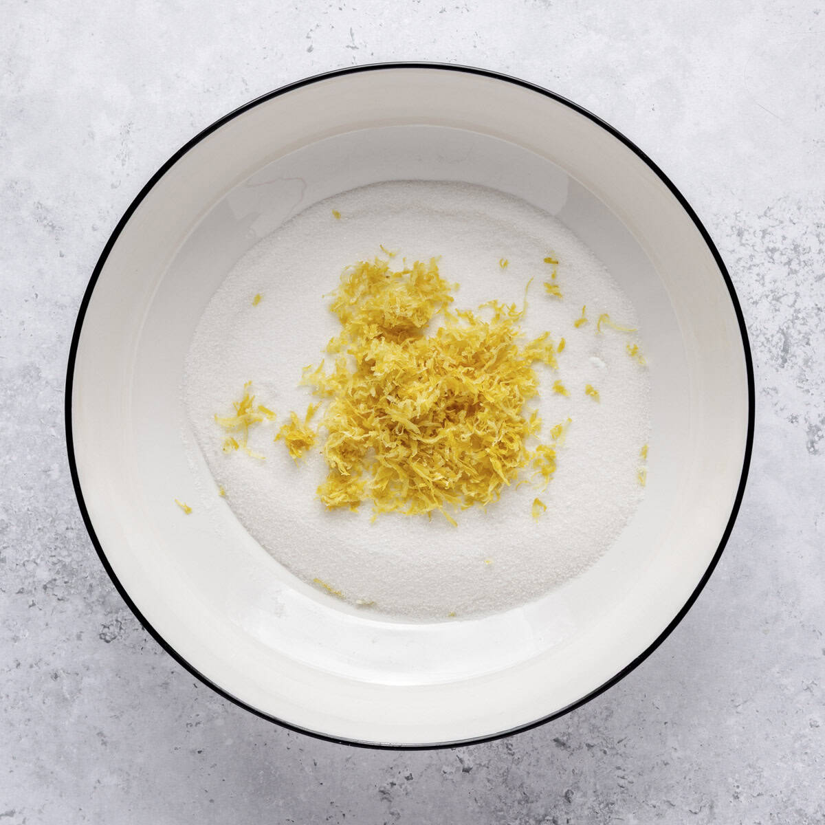 Sugar and lemon zest in a bowl.