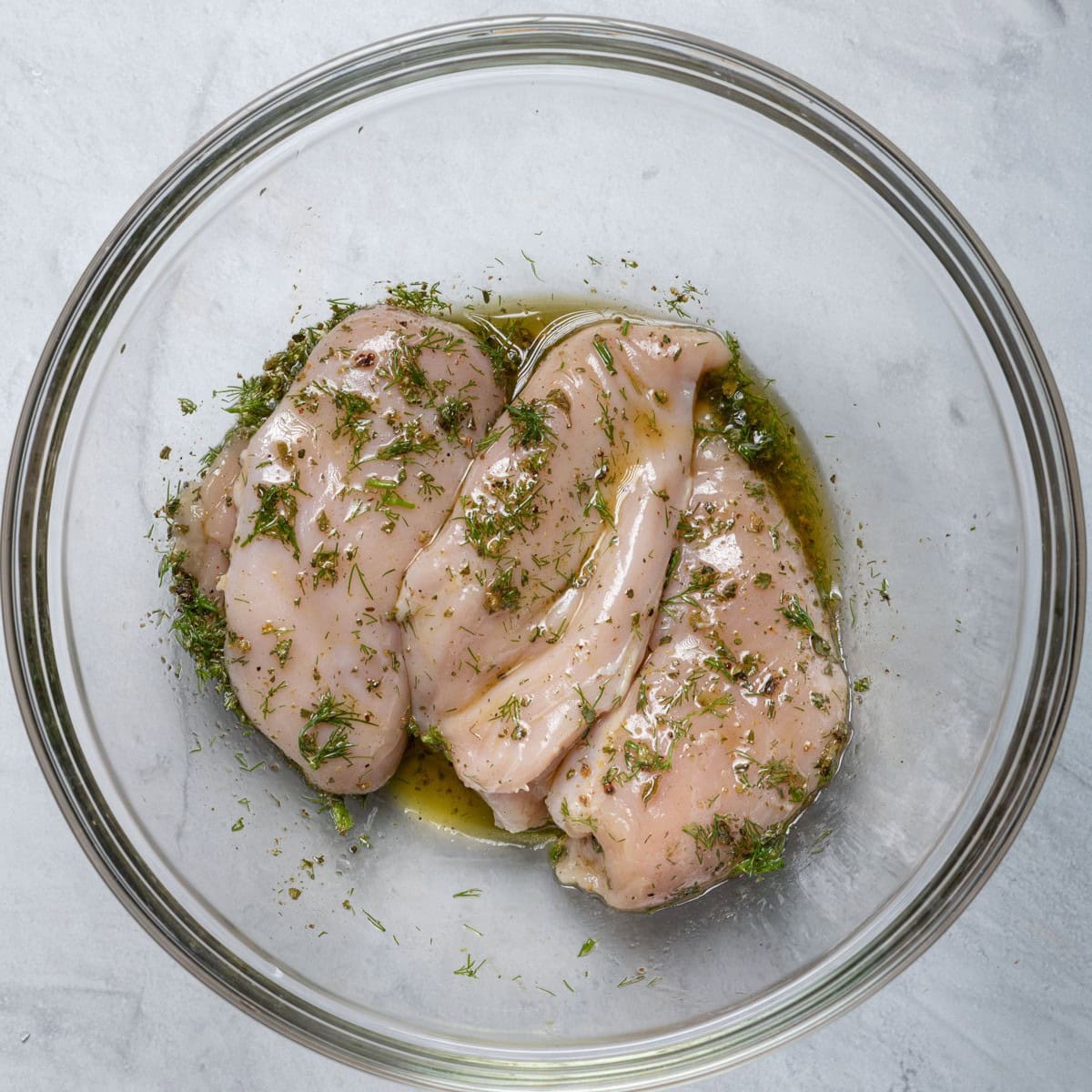 Chicken coated with the marinade.