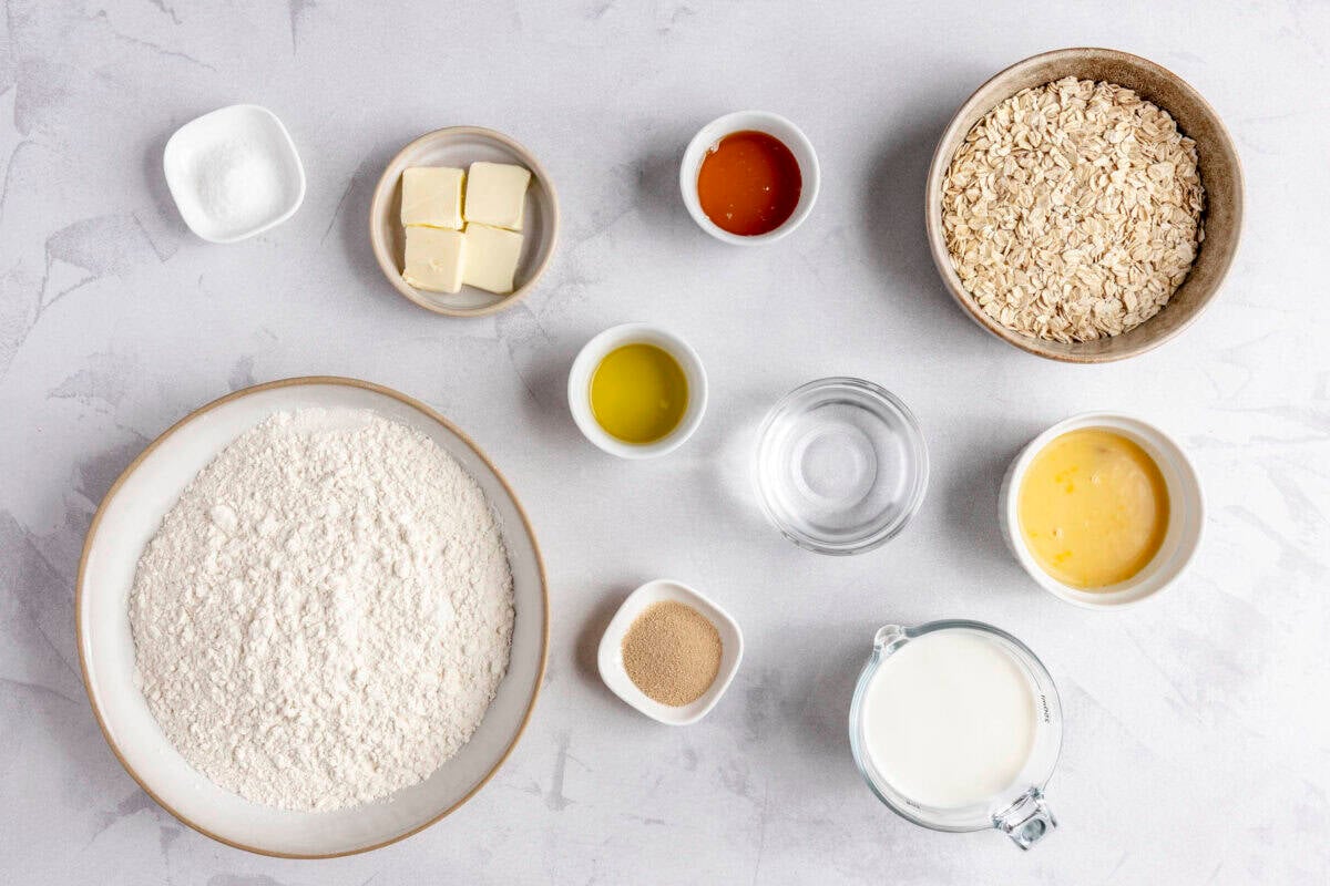 Ingredients for recipe: flour, rolled oats, butter, water, honey, salt, instant dry yeast, olive oil and egg.