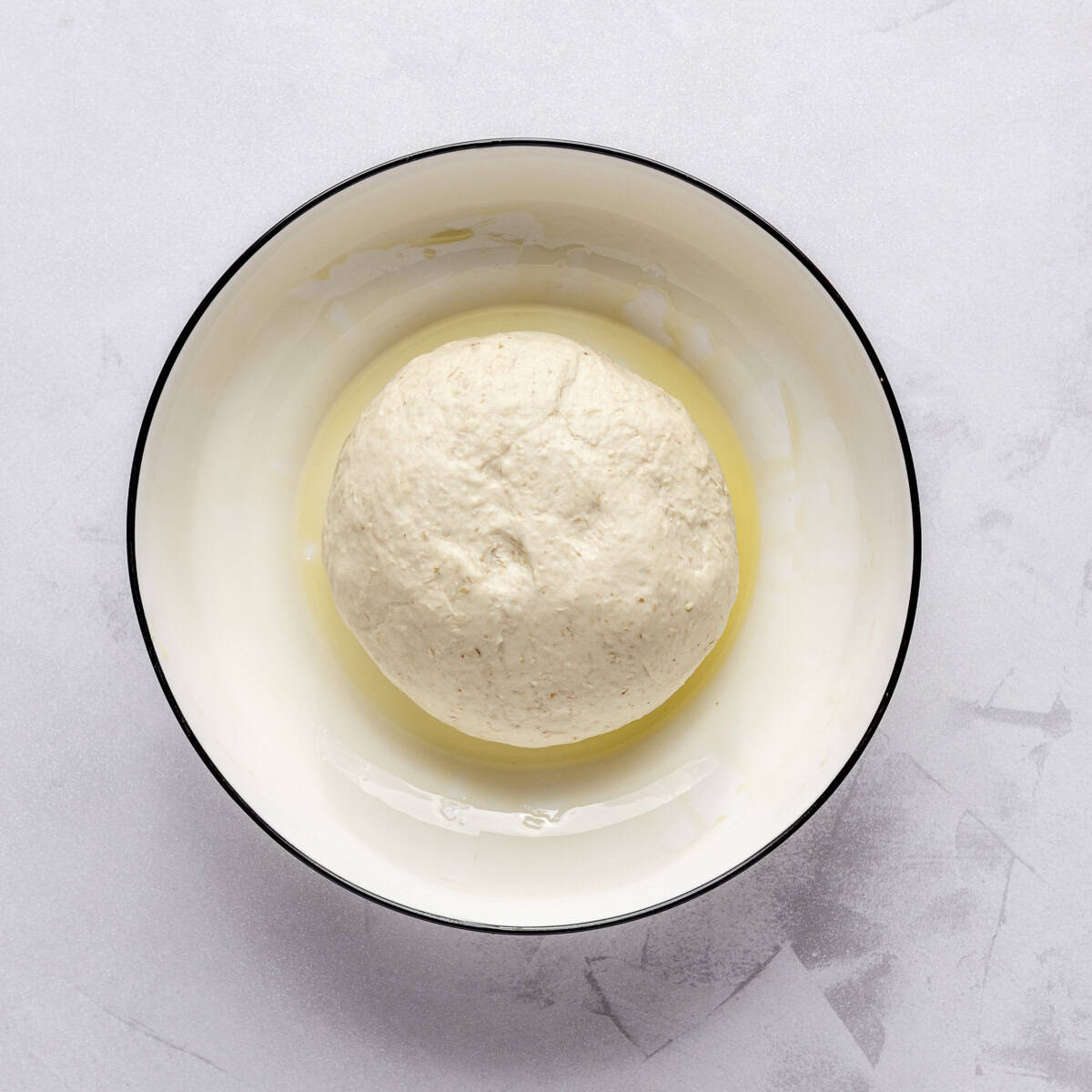 After kneading until smooth and in an oil coated bowl, before rising.