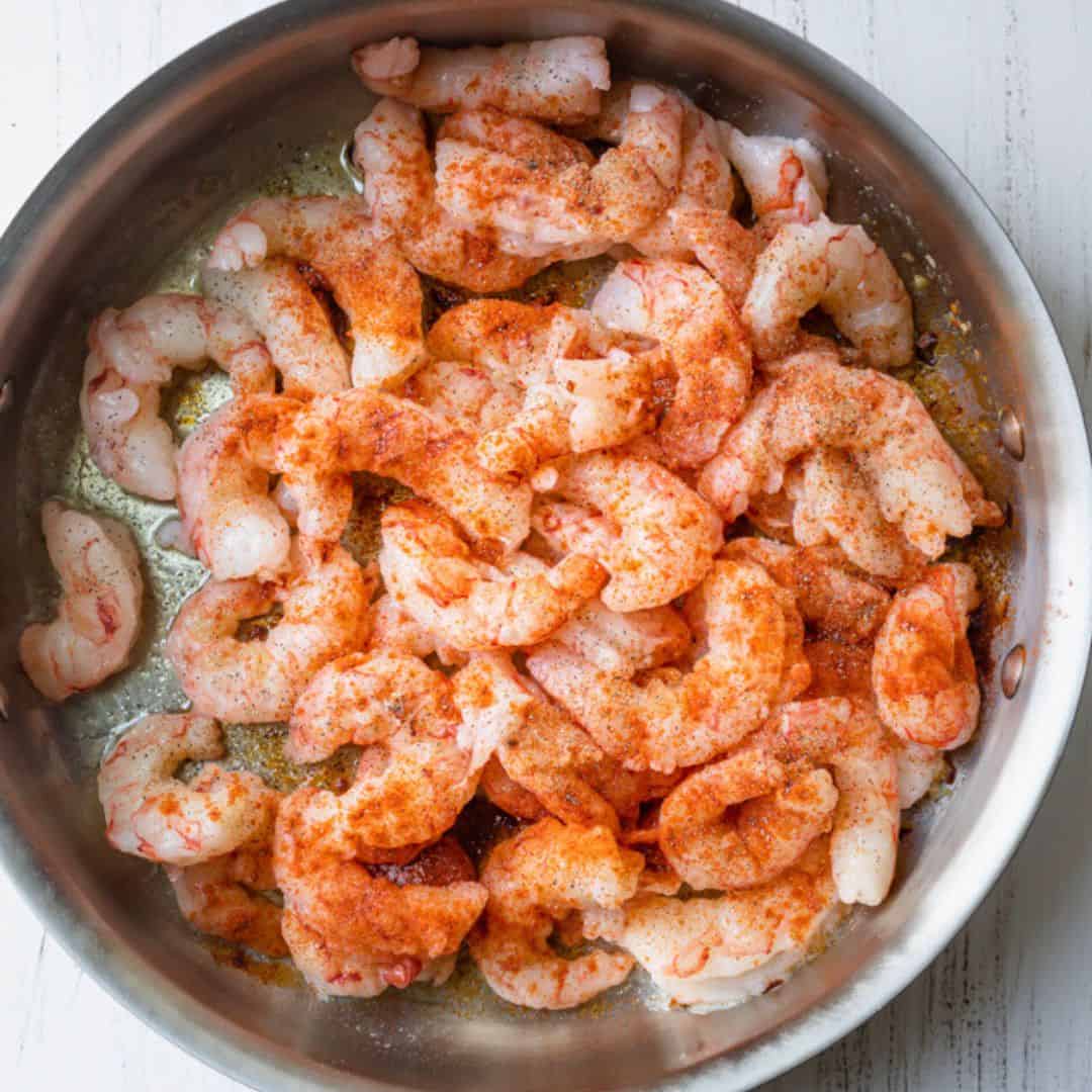 Seasoned shrimp added to pan.