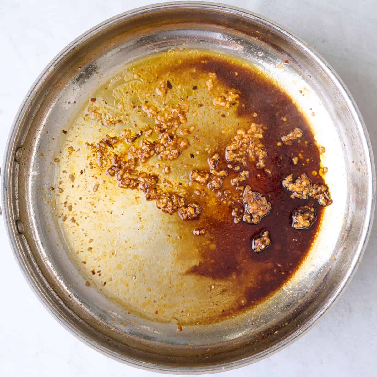 Soy sauce, honey, and lime juice added to skillet.