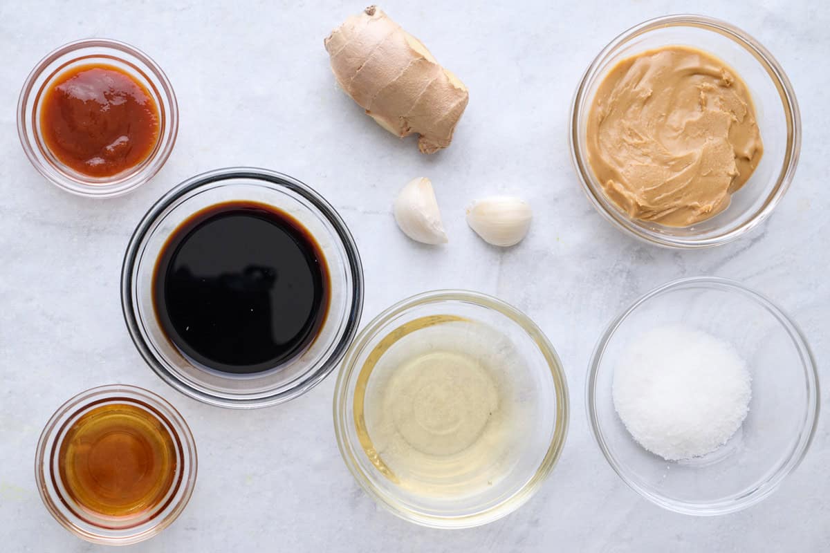 Ingredients for recipe: soy sauce, rice vinegar, creamy peanut butter, sesame oil, sriracha, sugar, ginger and garlic.