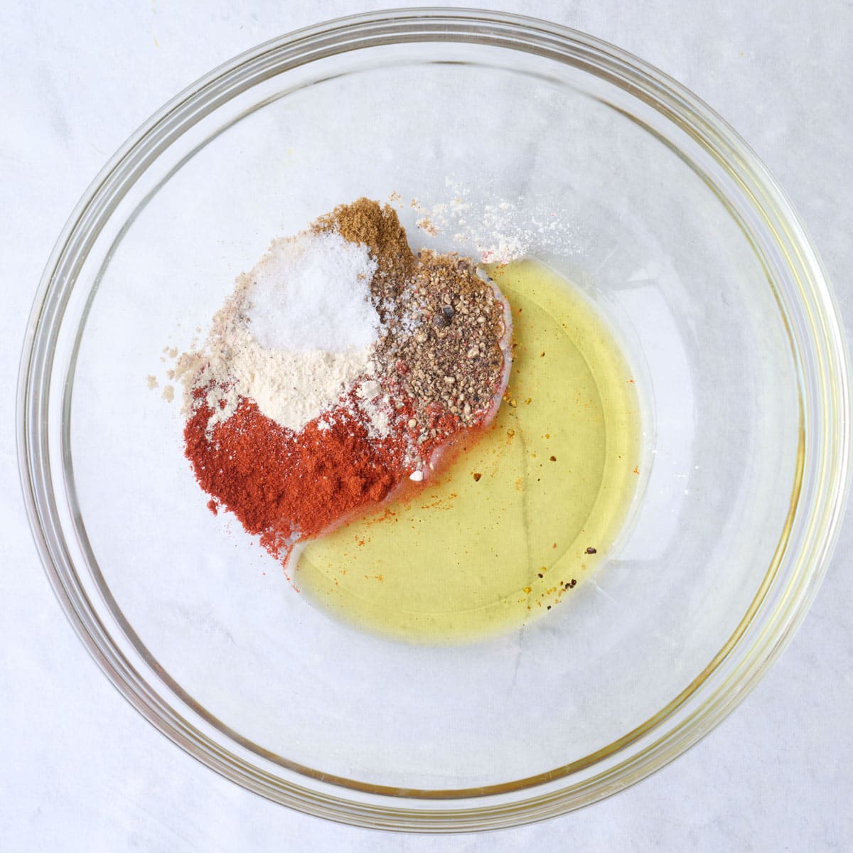 Seasonings and oil in a small bowl.