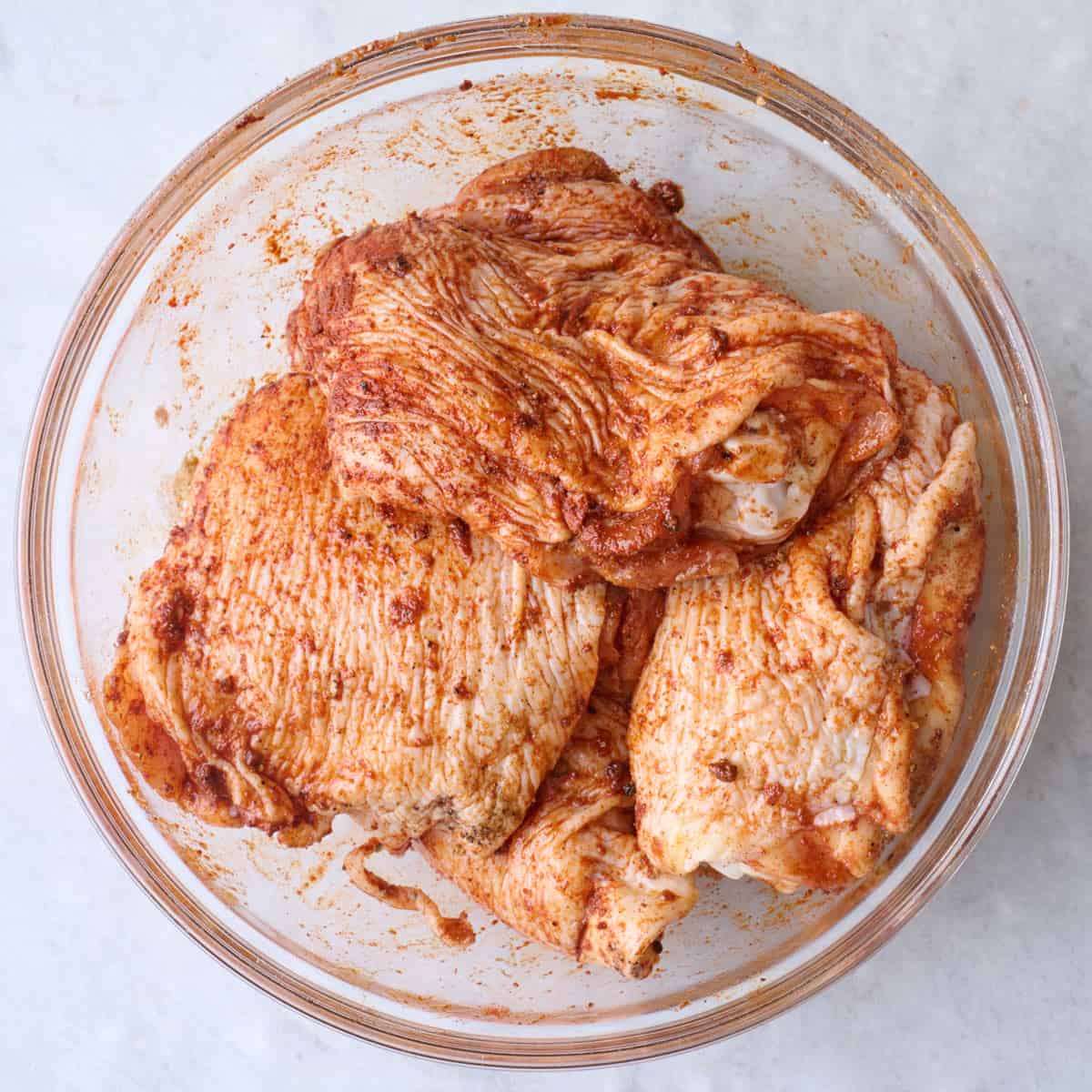 Chicken thighs tossed in spices.