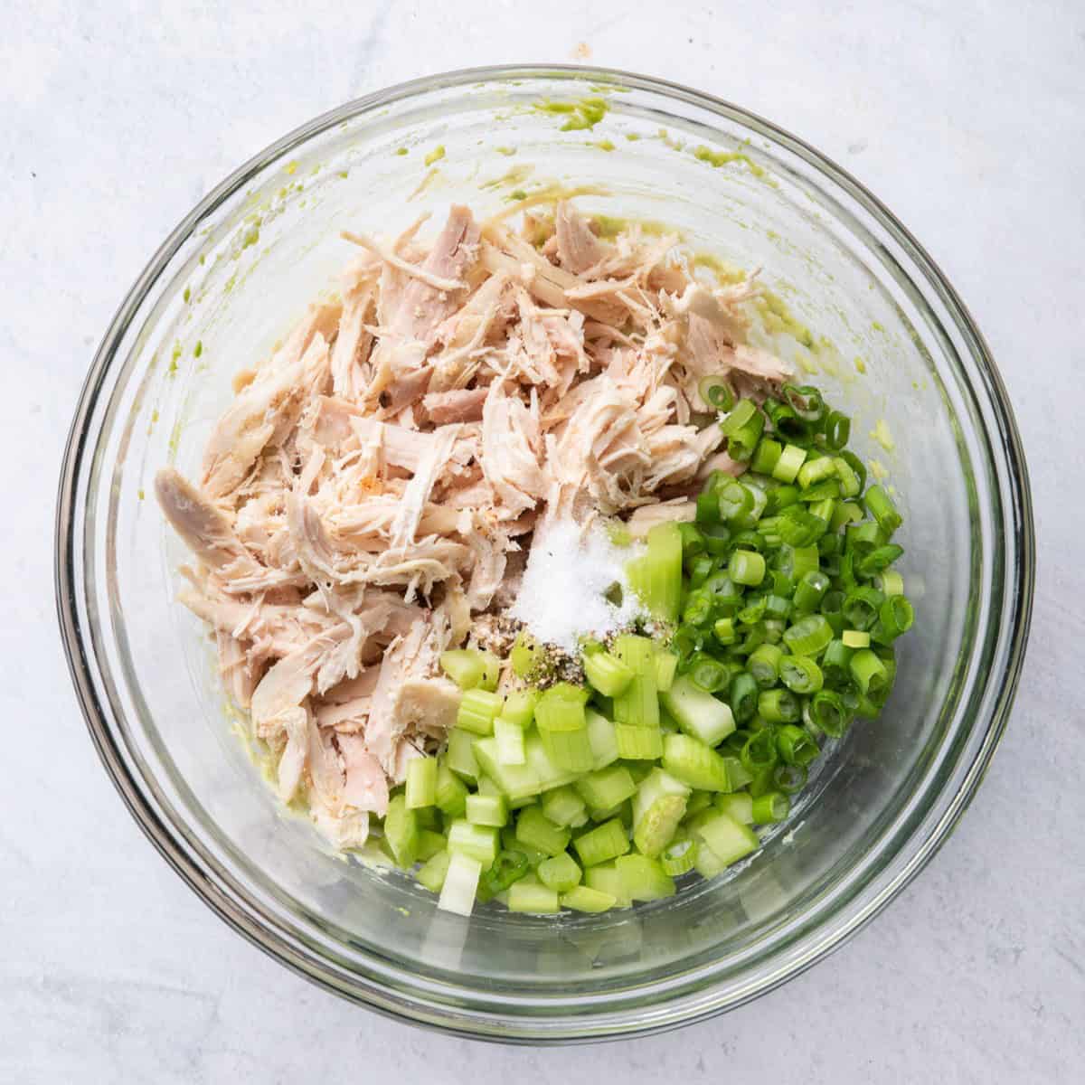 Shredded chicken, celery, green onions, salt and pepper added on top of avocado dressing.
