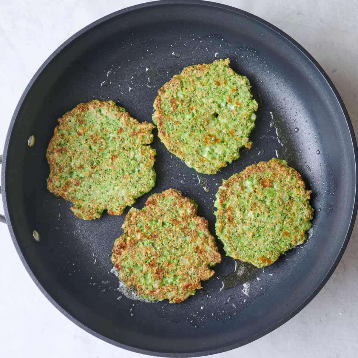 After flipping to show brown and crisp fritters.
