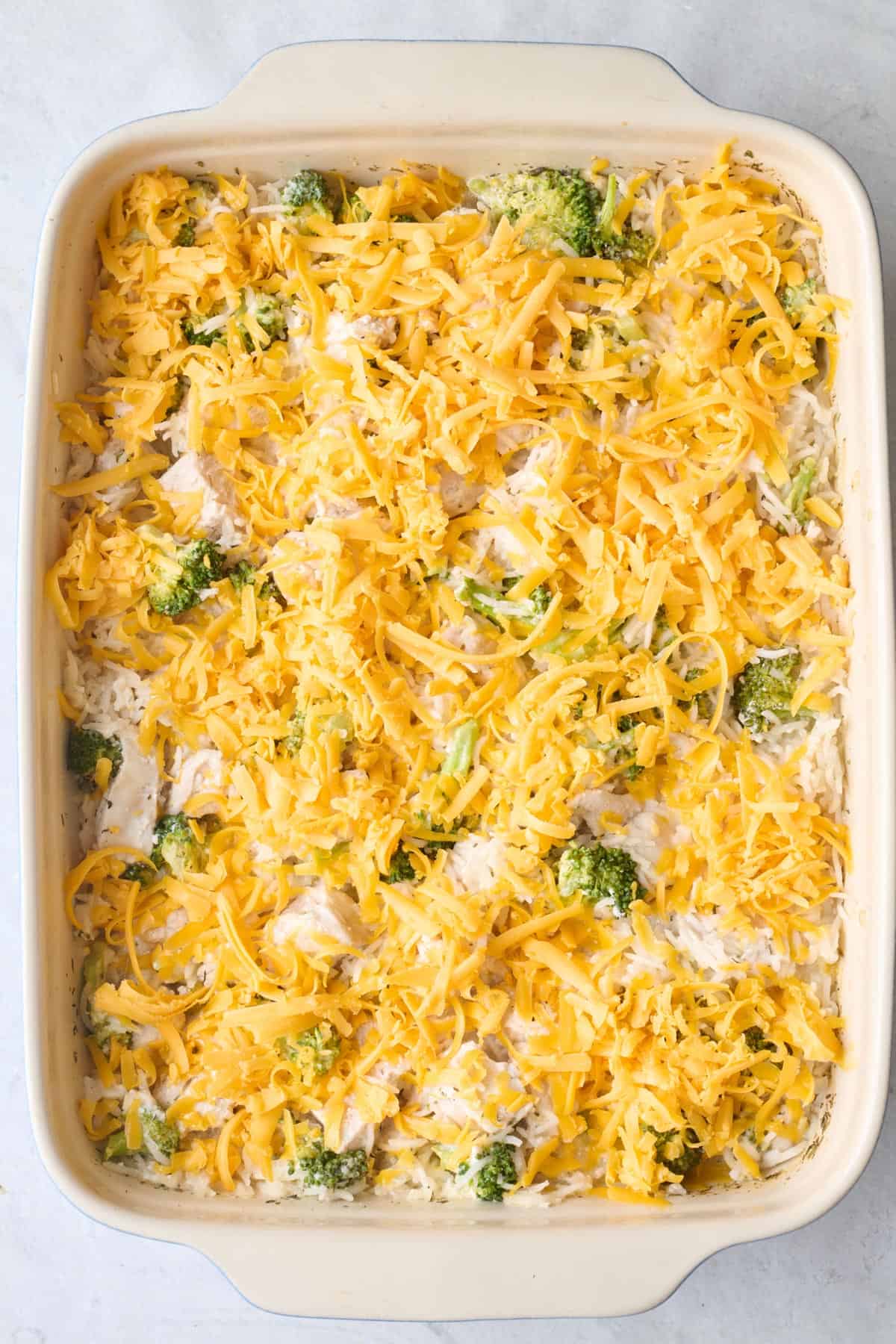 Shredded cheese added on top before baking.