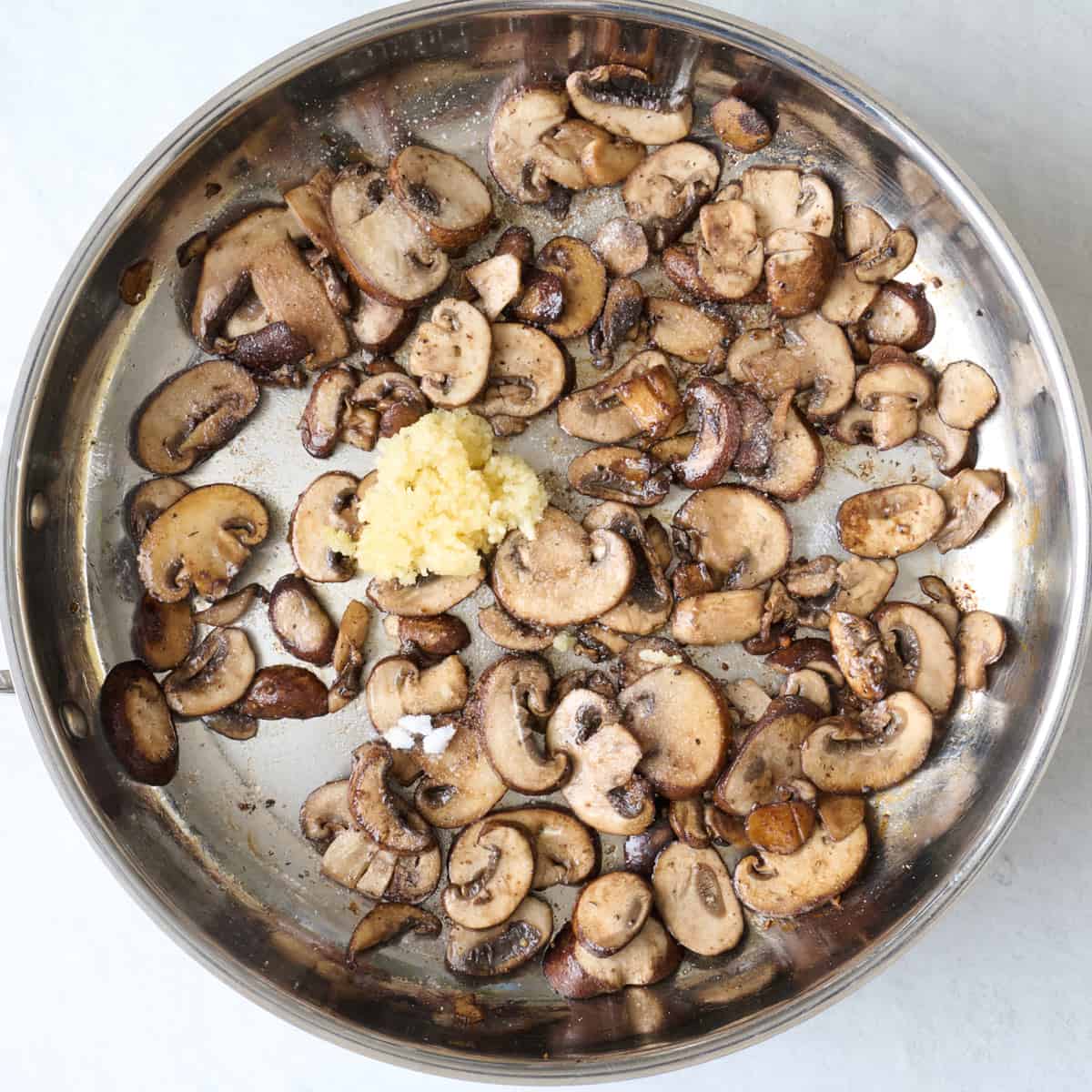 After mushrooms are golden brown with salt and garlic added.