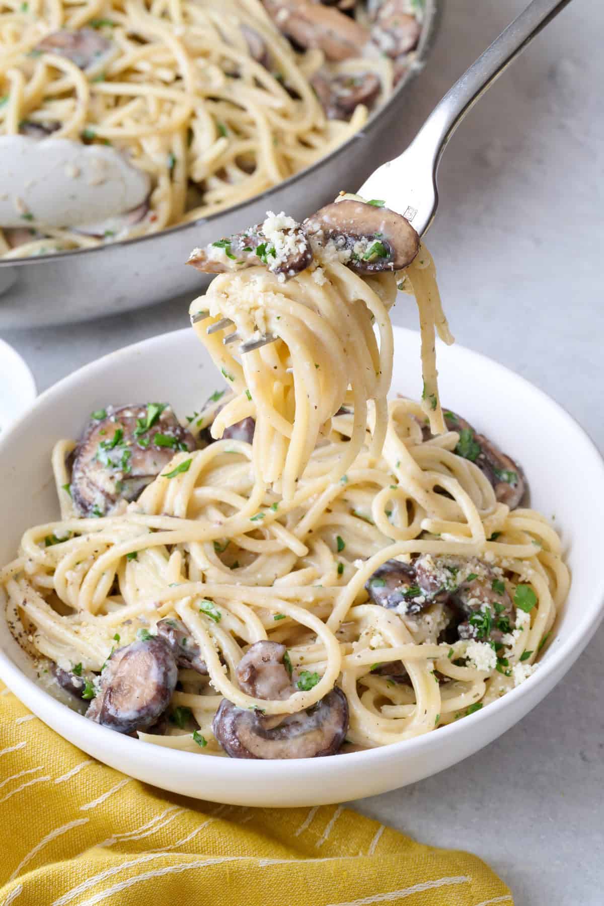 Easy mushroom pasta in a bowl with a fork lifting up a bite.
