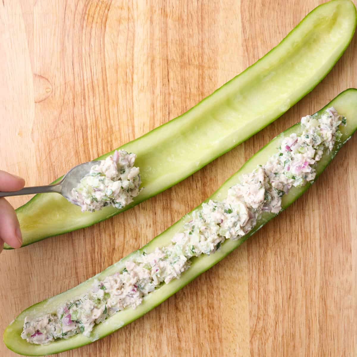 Spooning recipe into halved and cored cucumber.