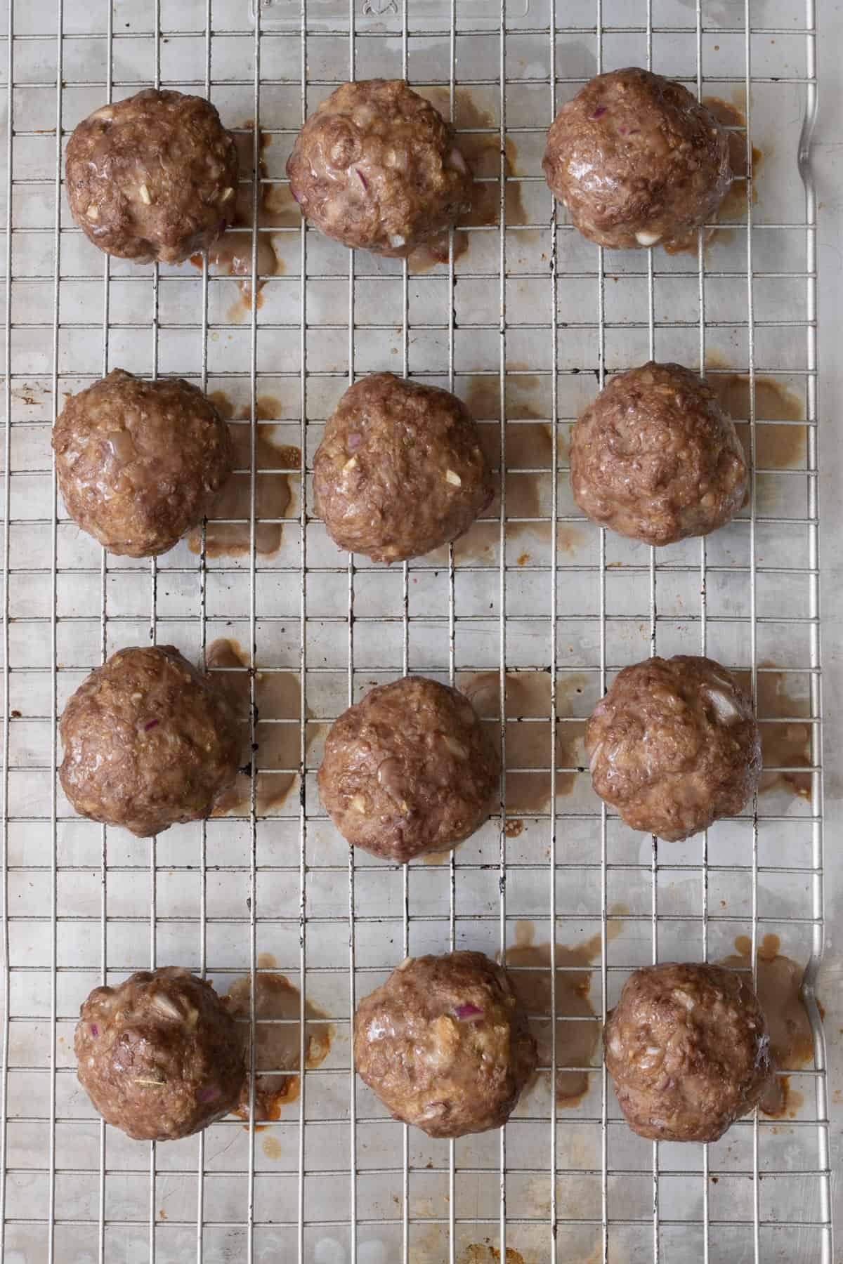 Cheese stuffed meatballs on wire rack after baking