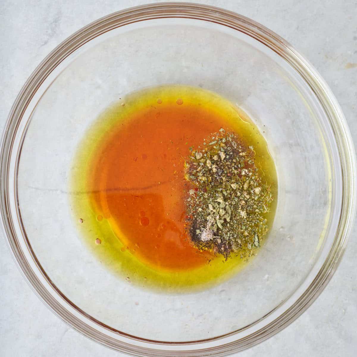 Dressing ingredients in a bowl before mixing.