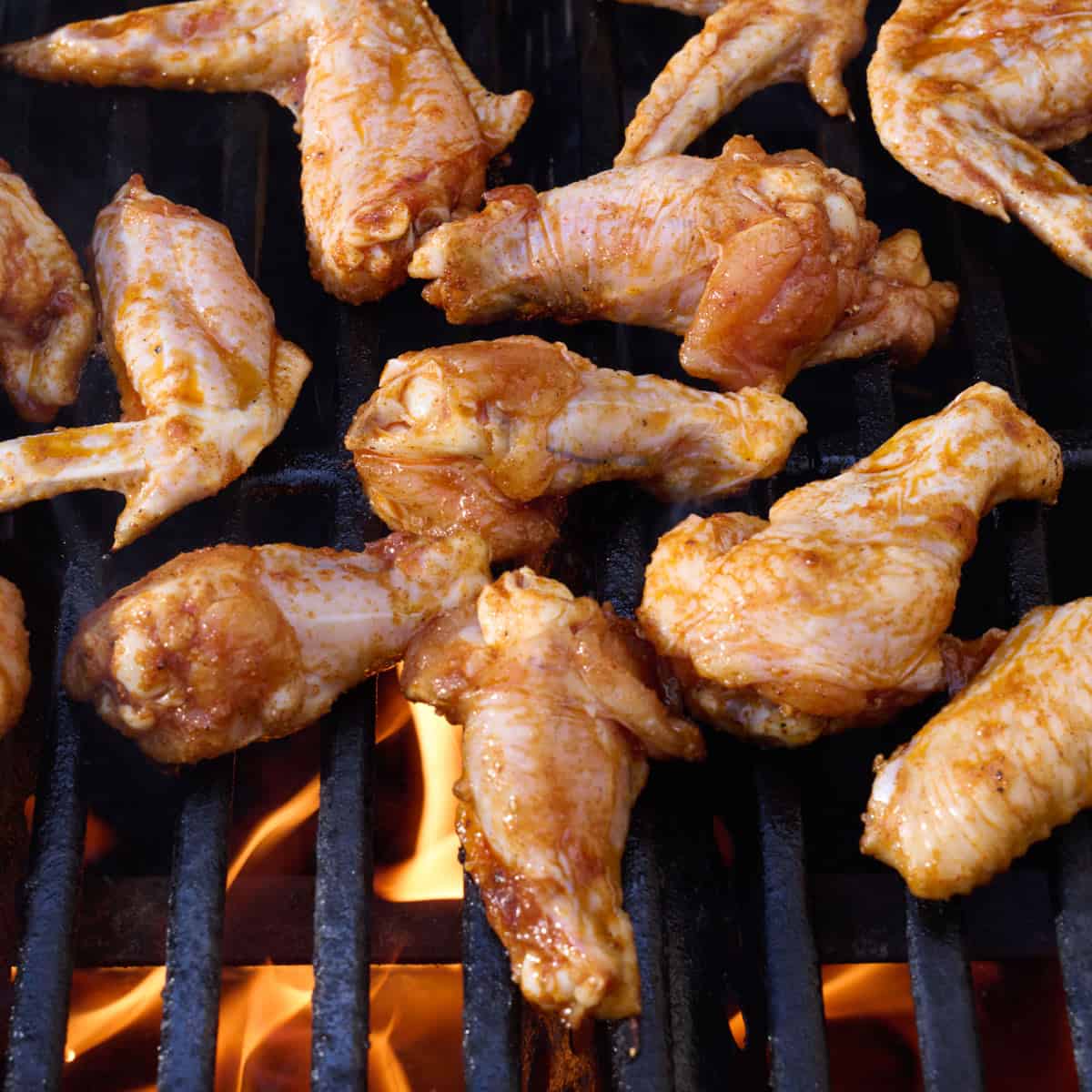 Seasoned wings on an outdoor grill.