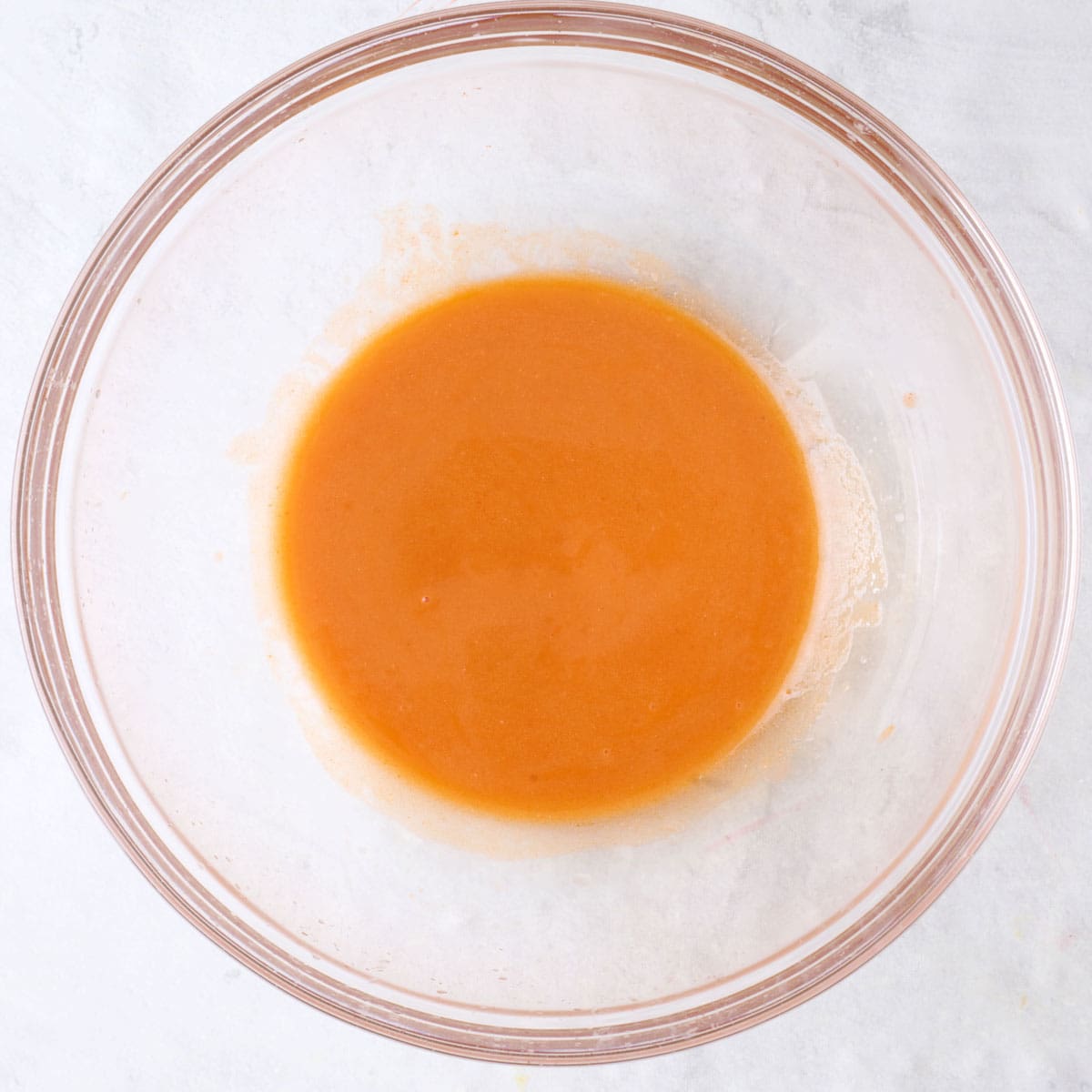 After mixing hot sauce in bowl.