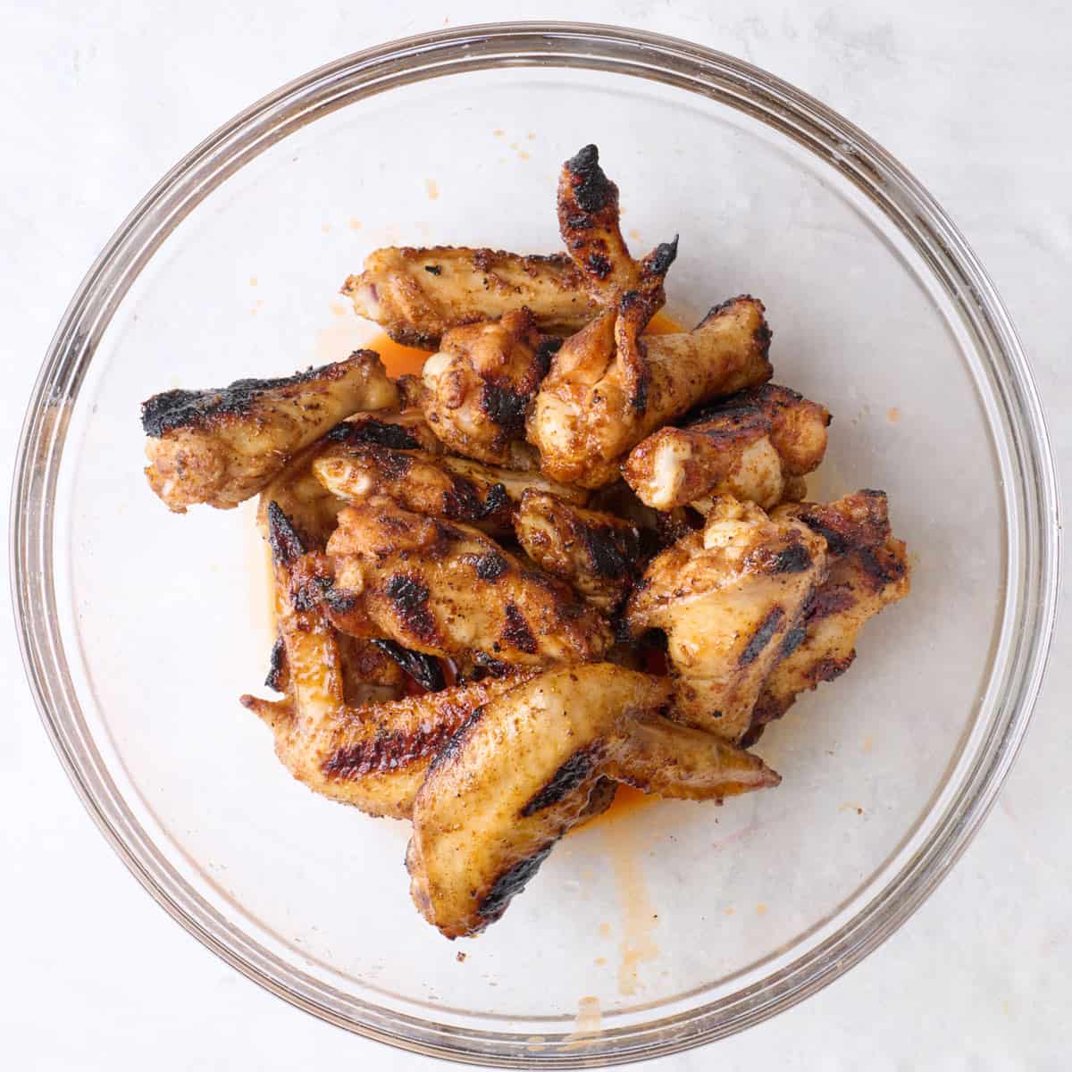 Chicken wings added on top of hot sauce before tossing.
