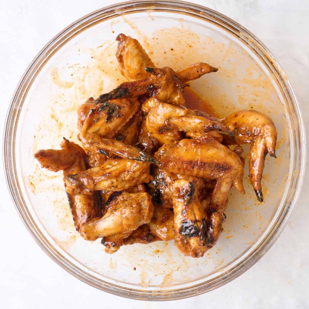After tossing wings in sauce.