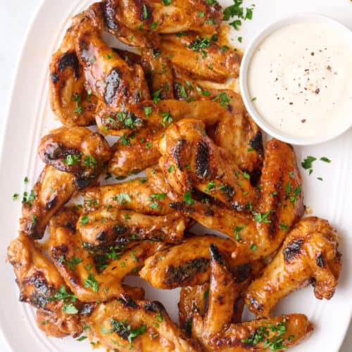 Grilled chicken wings recipe tossed in buffalo sauce.