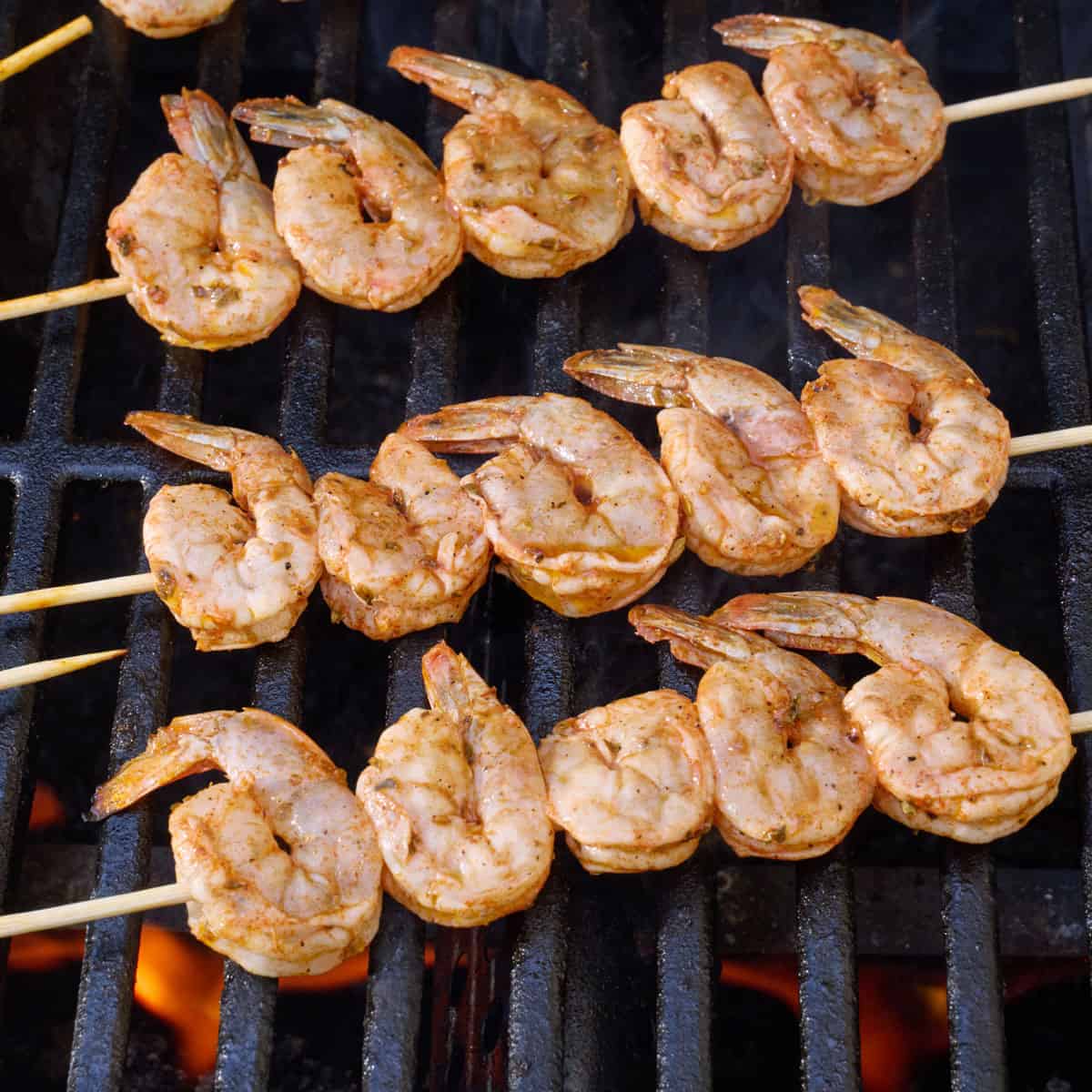 Shrimp skewers on grill.