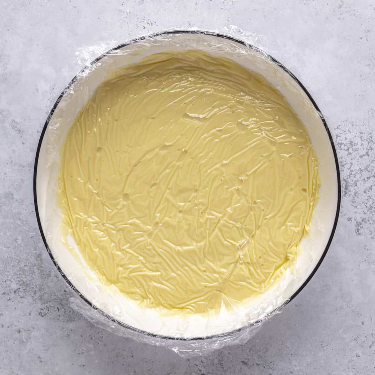 Plastic wrap pressed onto the top of the pudding before chilling.