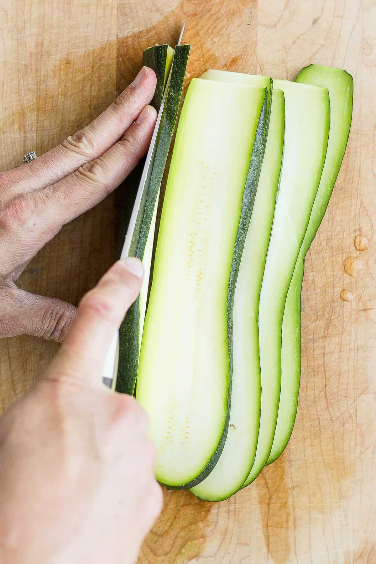 Slicing zucchini into planks.