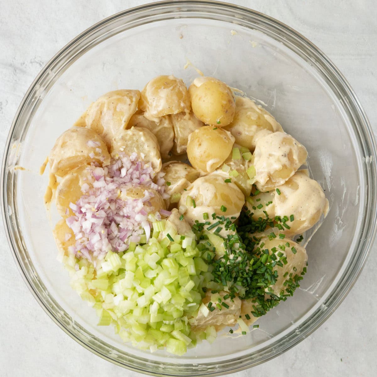 Celery, shallot, and chives added before tossing.