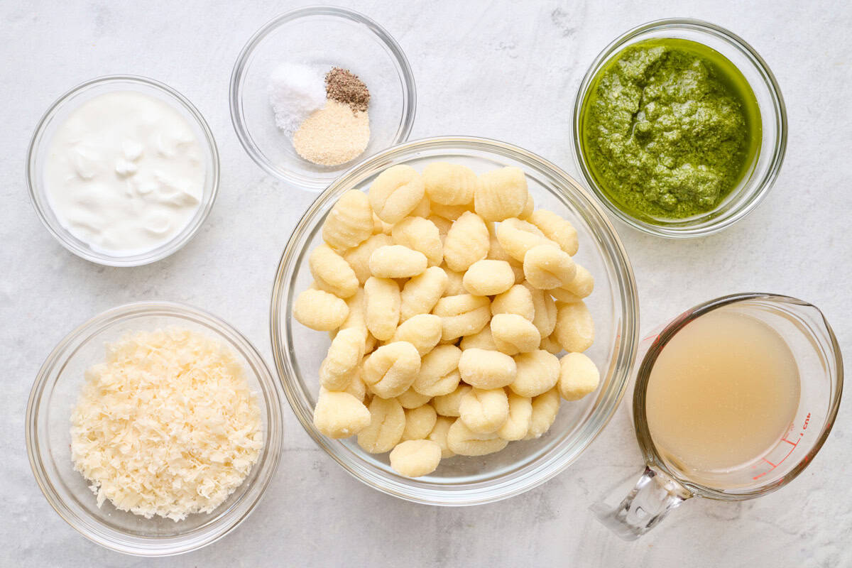 Ingredients for recipe: yogurt, grated parmesan, spices, gnocchi, pesto and broth.