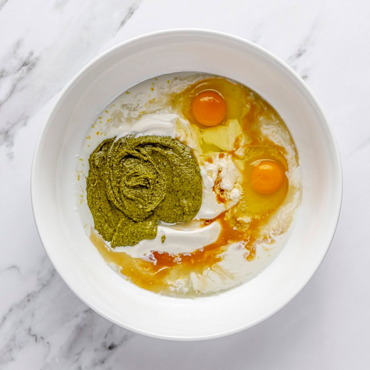 Eggs, yogurt, milk, pistachio butter, lemon juice and vanilla added to sugar.