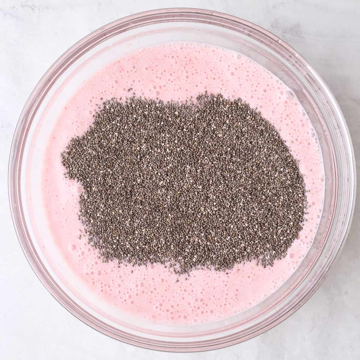 Strawberry milk mixture in a bowl with chia seeds on top.