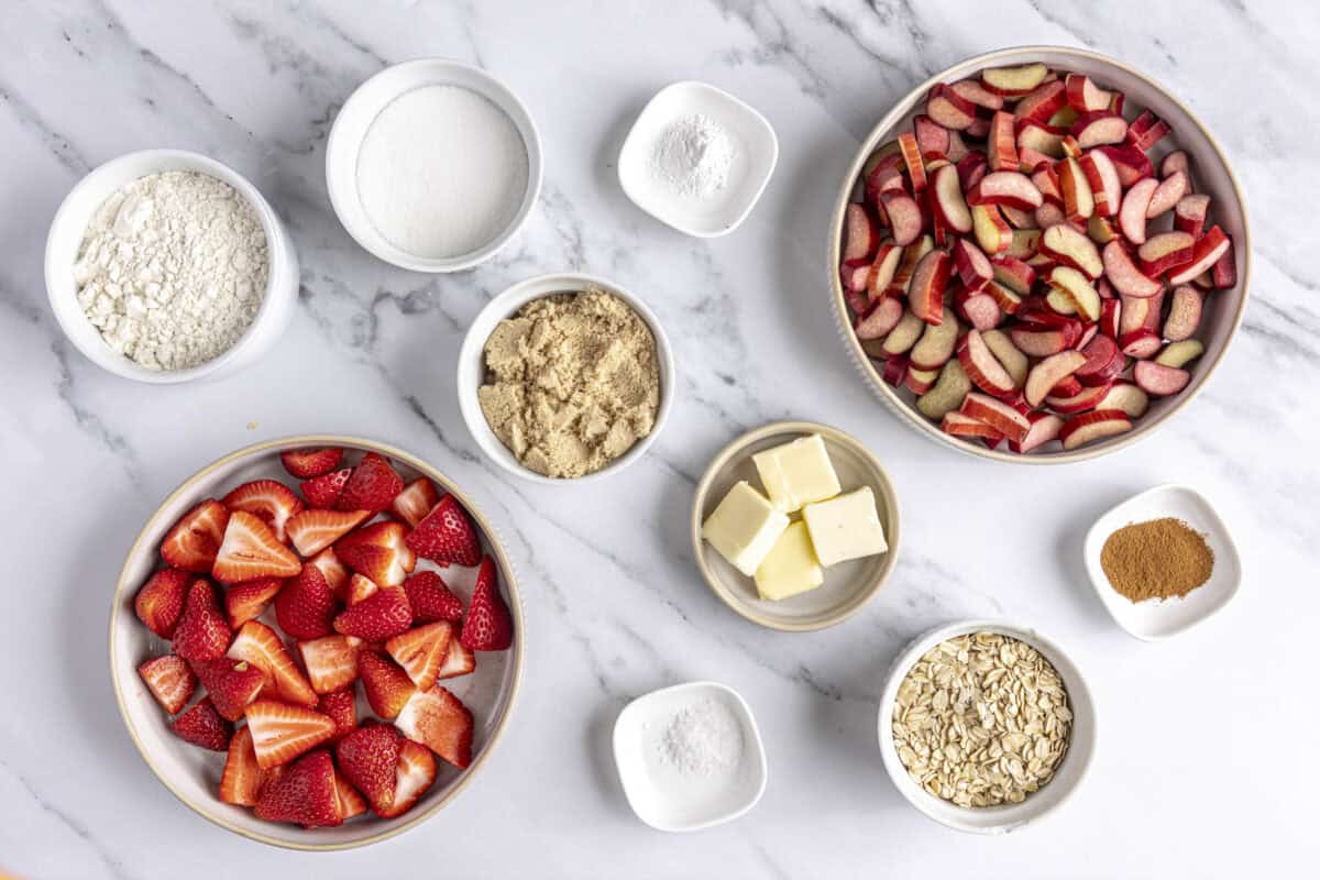 Ingredients for recipe: fresh strawberries, rhubarb, sugar, cinnamon, flour, rolled oats, brown sugar, baking powder, salt and butter.