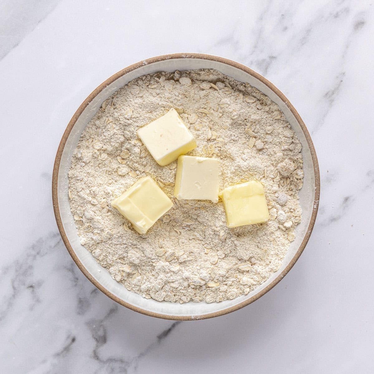 Cubed cold butter added on top of dry ingredients.