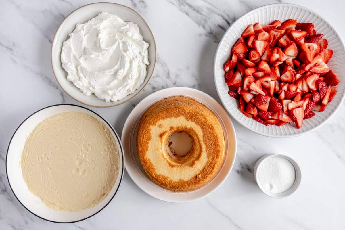 Ingredients for recipe: homemade vanilla pudding recipe, whipped cream, angel food cake, quartered fresh strawberries, and sugar.
