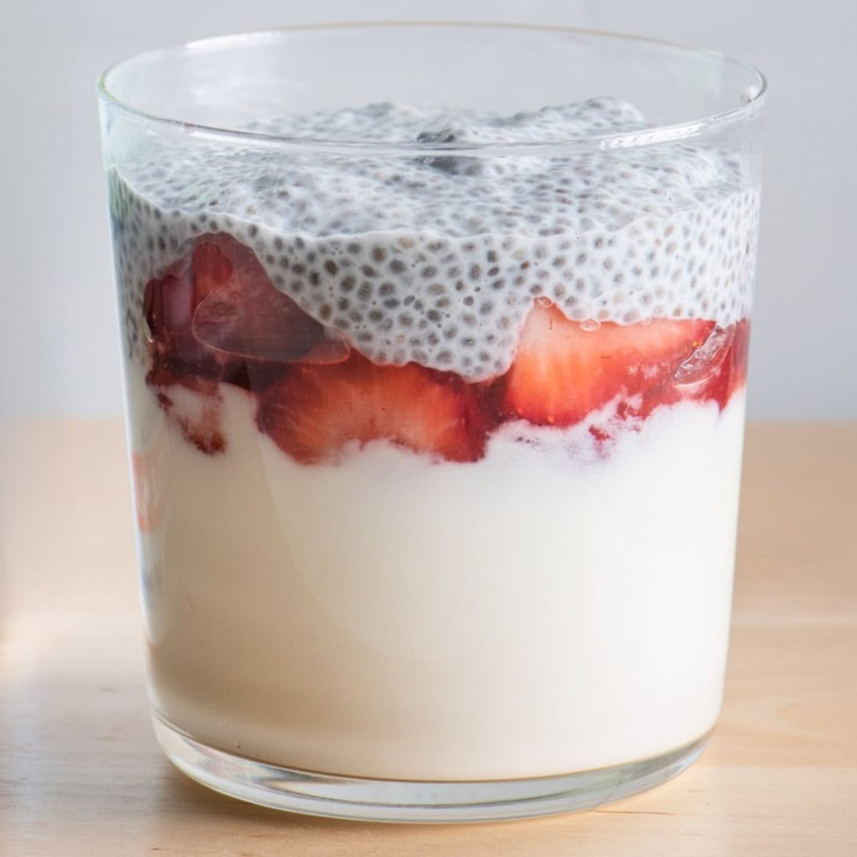 Chia pudding layer adding to cup.