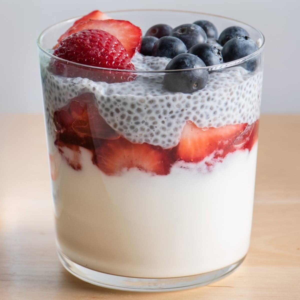 Layered yogurt chia pudding with strawberries and blueberries.