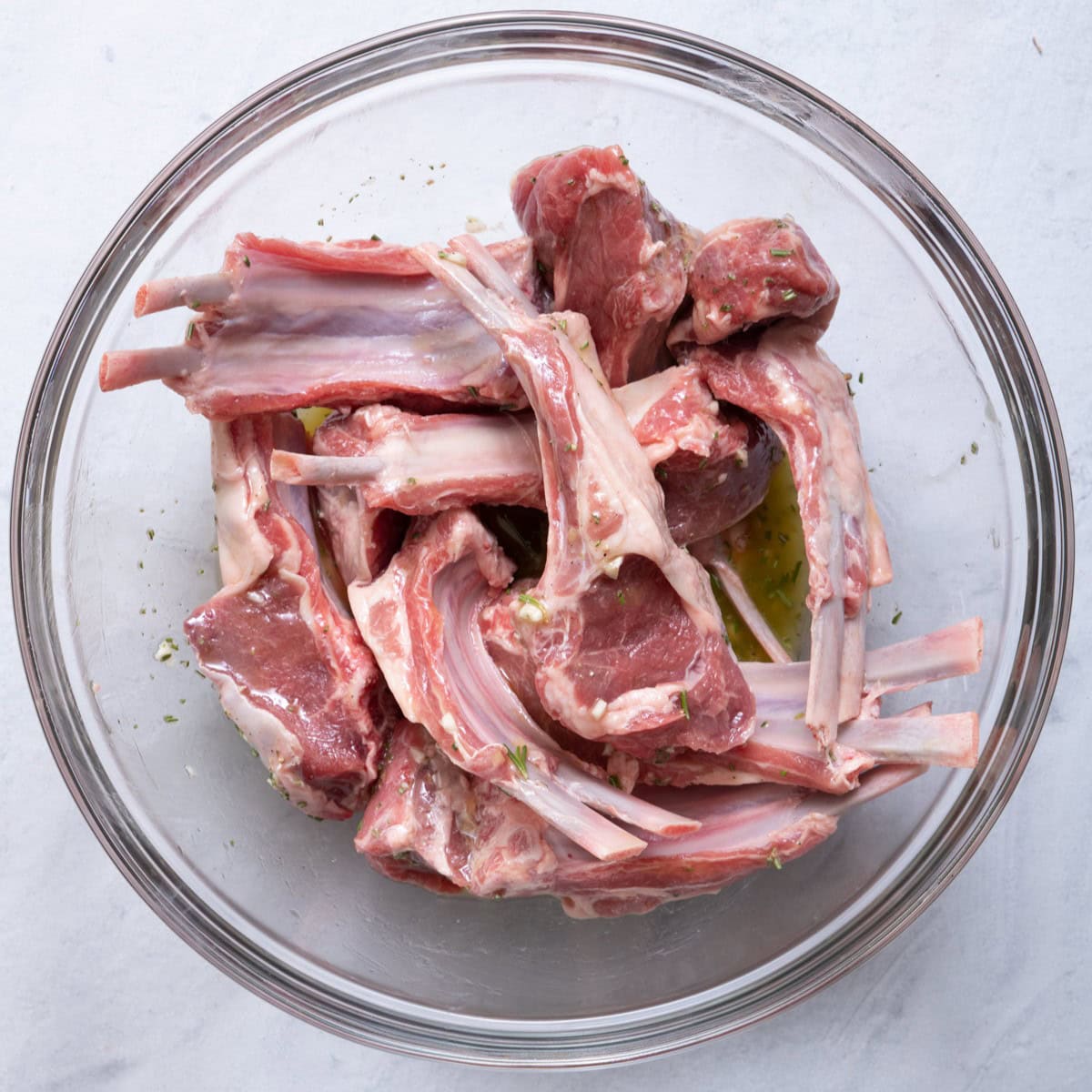 Lamb chops added on top of marinade.