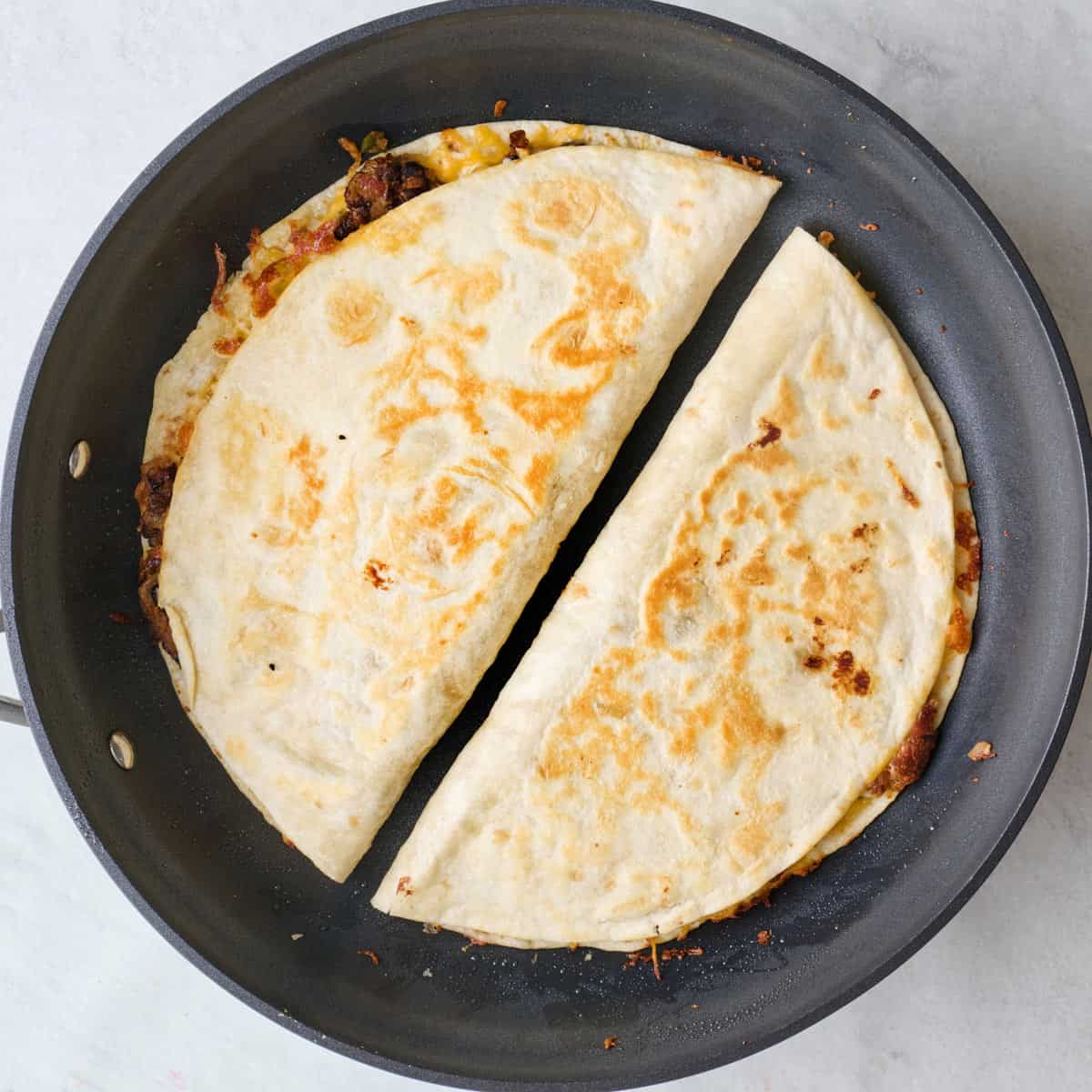 After flipping to show crispy tortilla.