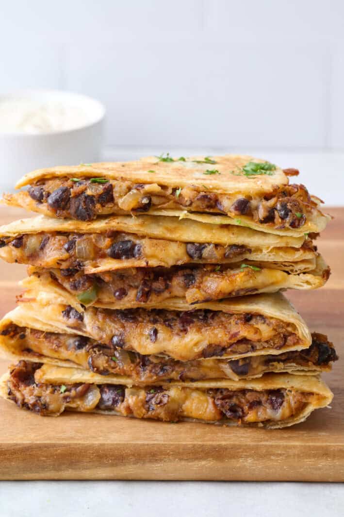 Stack of cheesy black bean quesadillas.