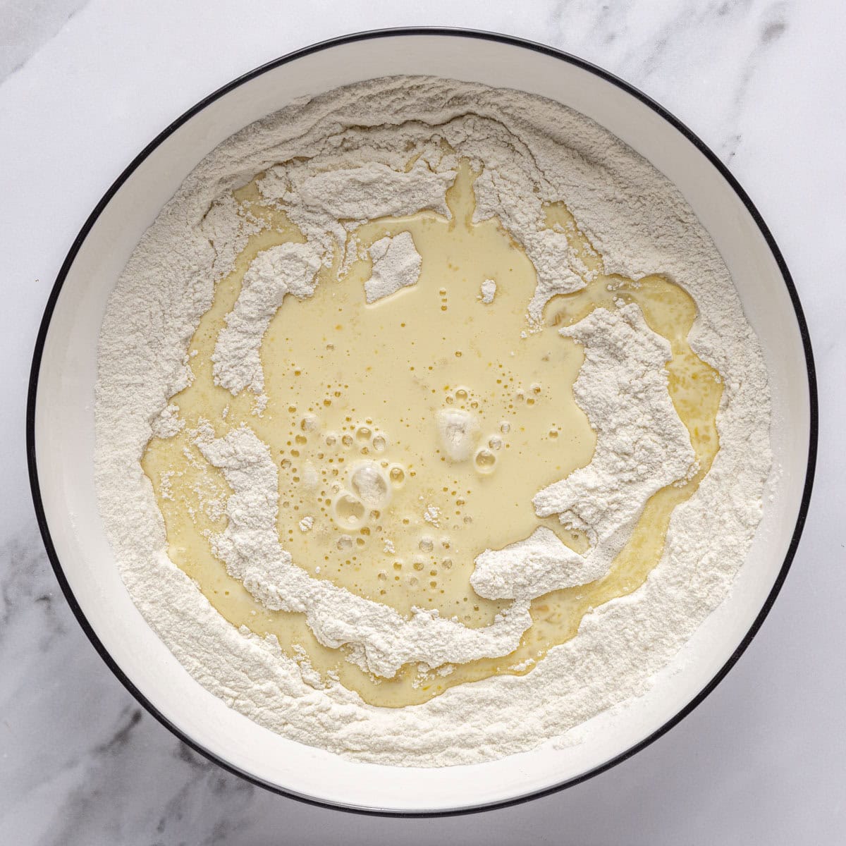Dry ingredients after combined with egg mixture poured on top.