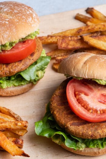 Homemade chickpea burgers assemble on a bun served with fries.
