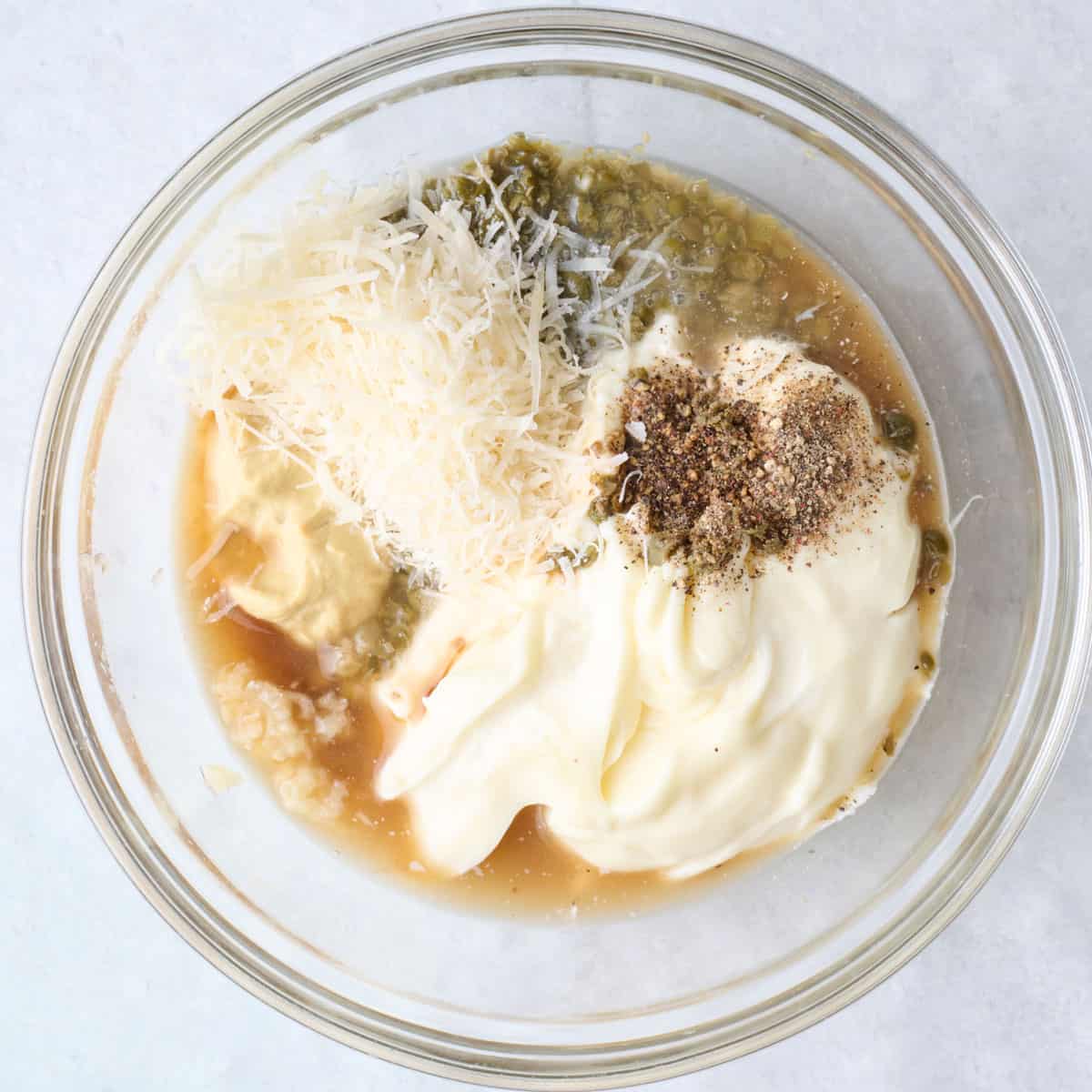Dressing ingredients in a bowl before mixing.