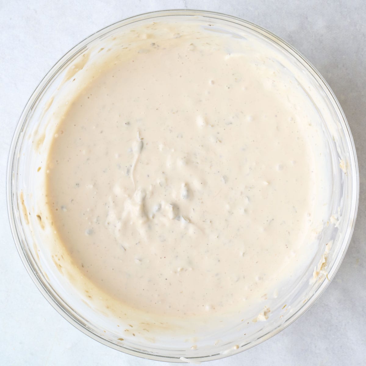 Homemade caesar dressing in a bowl.