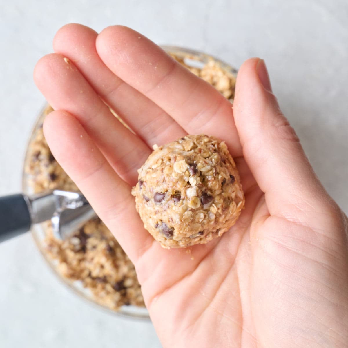 Roll energy balls in hand.