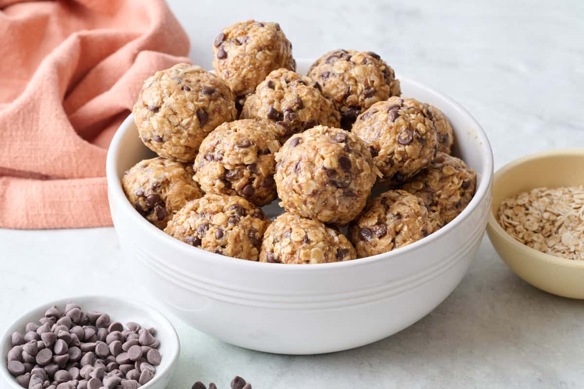 Best no bake energy bites recipe in a bowl with extra ingredients nearby.