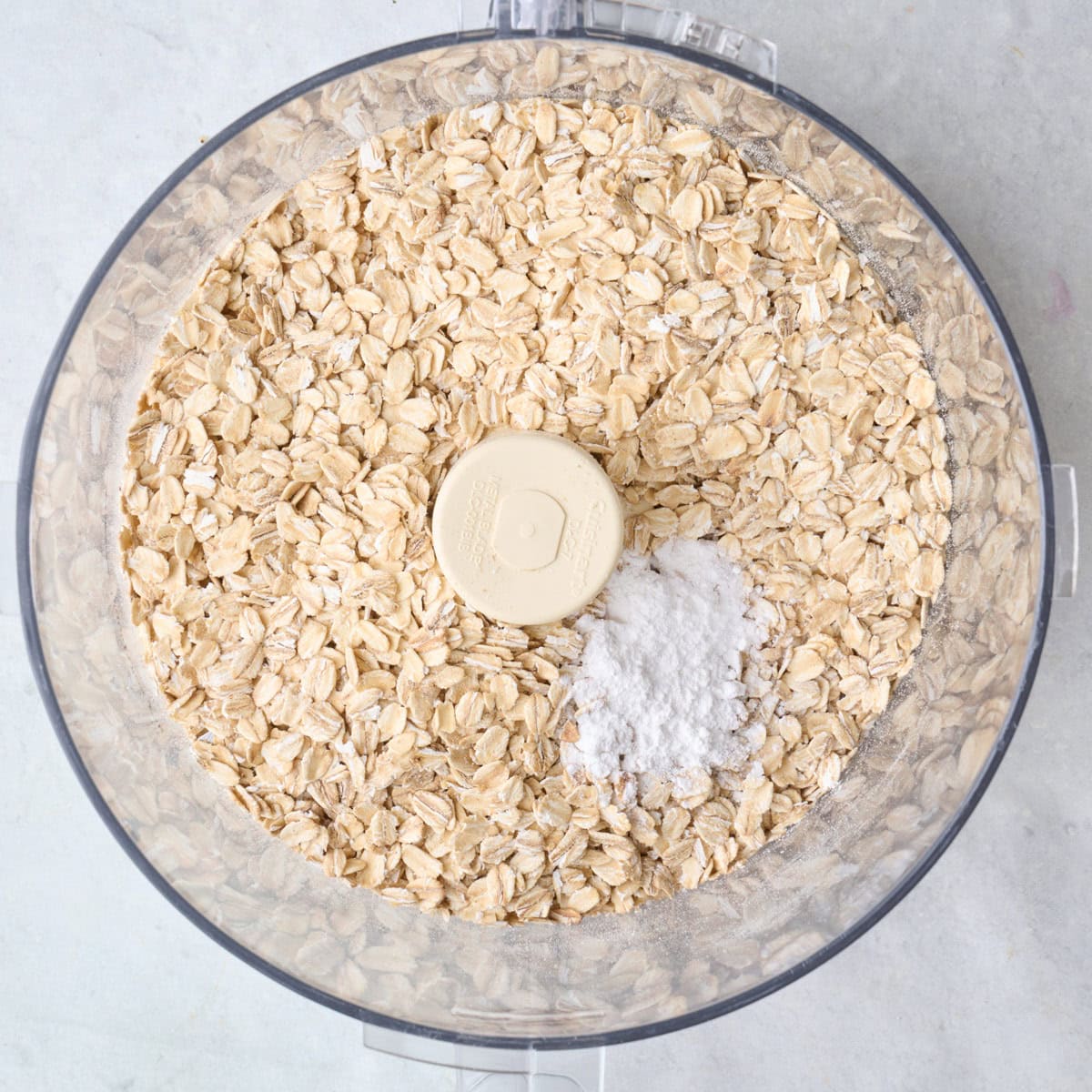 Oats, baking powder and salt in a food processor.