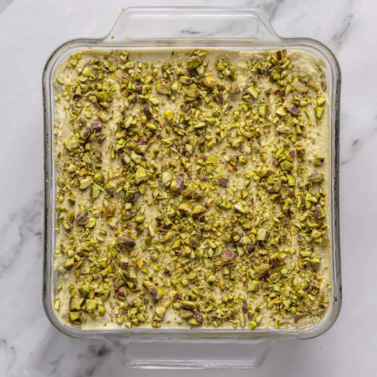 Remaining cream added after chilled and topped with crushed pistachios.